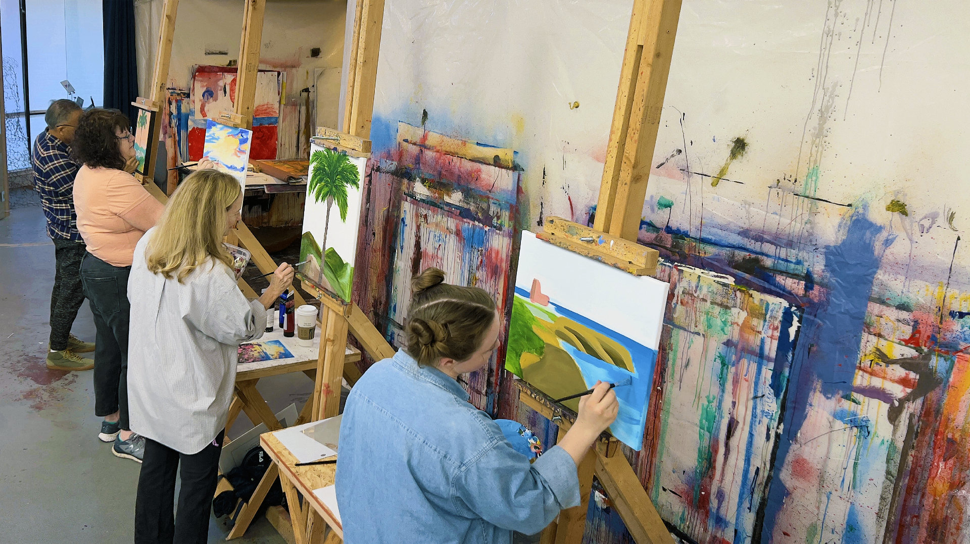 Artists painting at easels in the MoArt studio